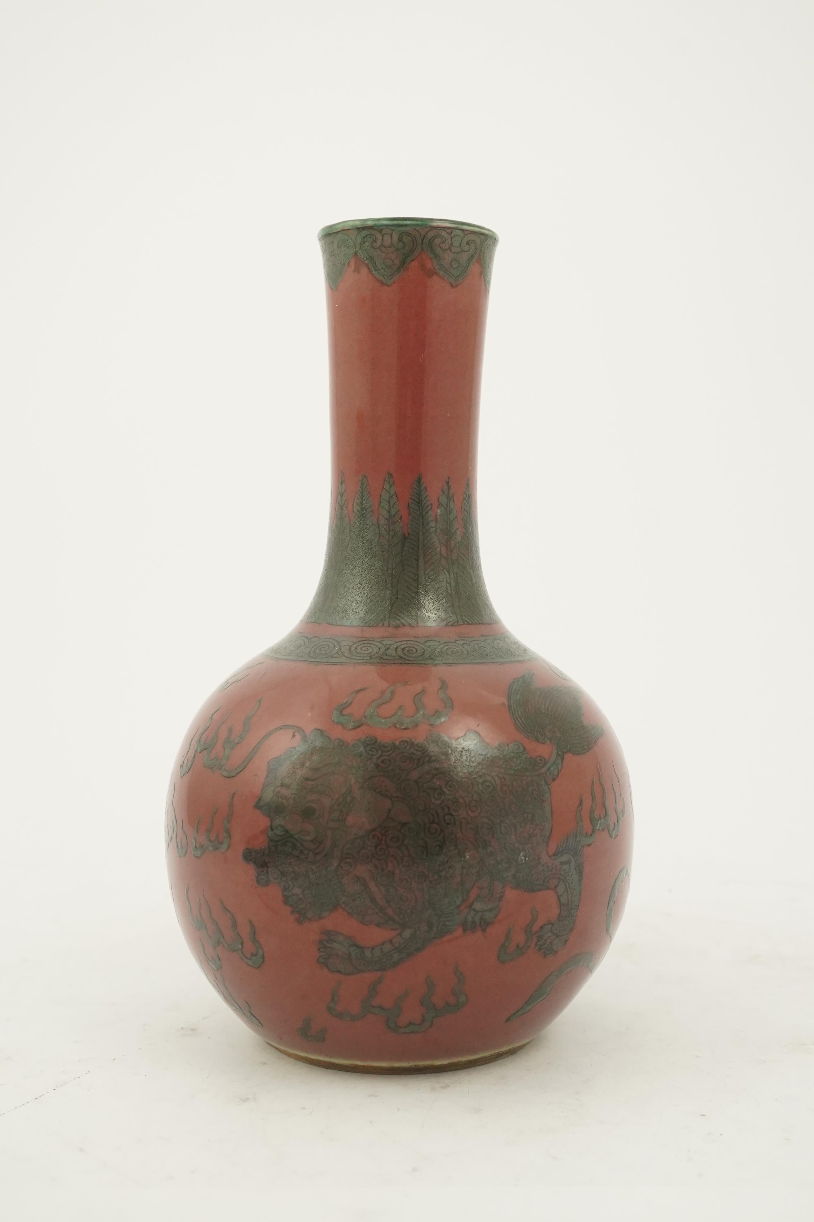 A Chinese green enamelled sang de boeuf ground 'lion' bottle vase, probably 18th century